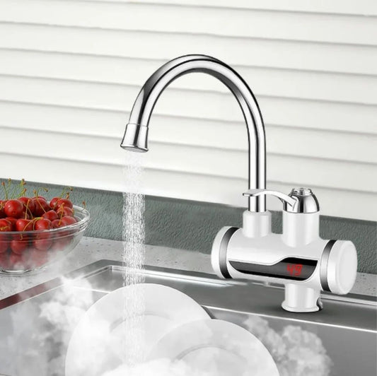 Modern kitchen faucet with water flowing into a sink, cherry bowl on the side.