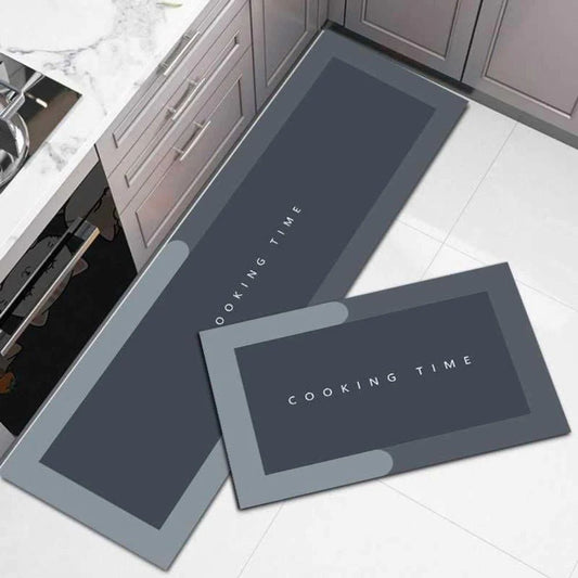 Two dark gray kitchen mats with 'Cooking Time' text on a tiled floor.