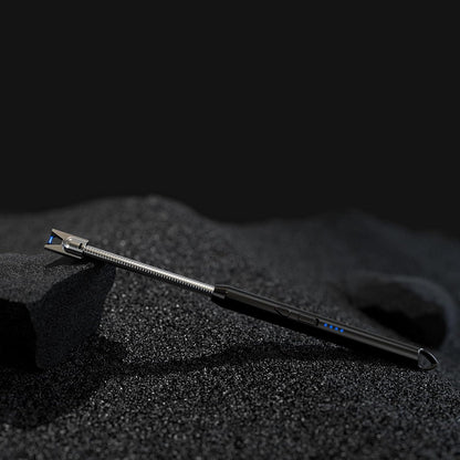 Metal tool on a textured black surface with a dark background