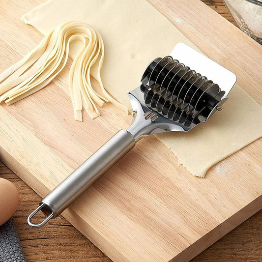 Pasta roller on a wooden surface with fresh pasta sheets