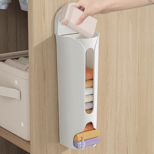 White vertical storage organizer with colorful folded clothes on a wooden surface